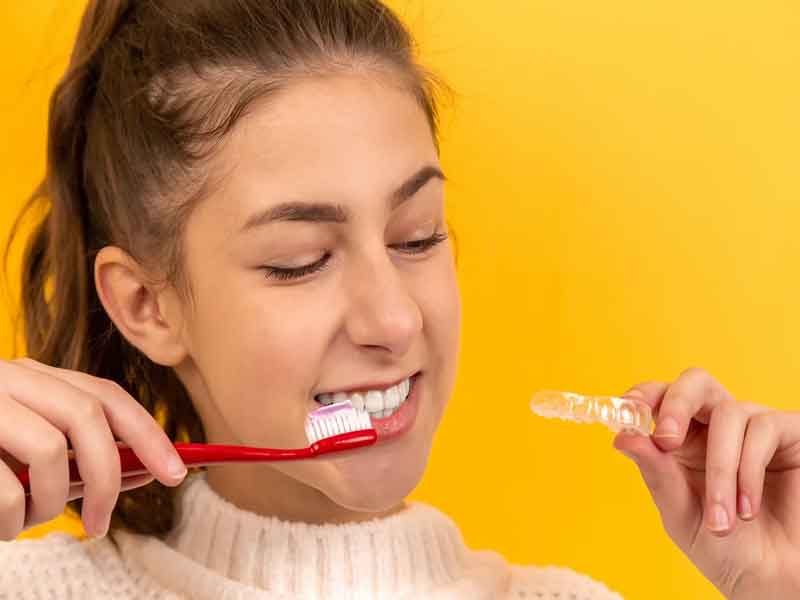 Girl is holding Brush and Braces 